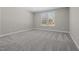 Neutral bedroom featuring a large window and plush neutral carpet at 2321 Calluna Ct, Fuquay Varina, NC 27526
