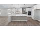 Modern kitchen featuring white cabinets, a large island, and stainless steel appliances at 2321 Calluna Ct, Fuquay Varina, NC 27526