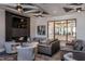 Community lounge with a fireplace, television, modern lighting, and comfortable seating at 2321 Calluna Ct, Fuquay Varina, NC 27526