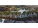 Serene aerial view featuring a lush pond, surrounded by mature trees and beautiful homes at 2609 Aster Ct, Apex, NC 27502