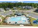 Aerial view showcasing the pool, clubhouse, and surrounding homes in a desirable neighborhood at 2609 Aster Ct, Apex, NC 27502
