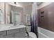 Bathroom featuring a single sink, tiled shower with a curtain, and neutral walls at 2609 Aster Ct, Apex, NC 27502