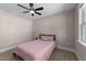 Bedroom features a ceiling fan, neutral walls, carpet, and a window at 2609 Aster Ct, Apex, NC 27502