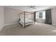 Spacious bedroom featuring a four-poster bed, neutral paint and a ceiling fan at 2609 Aster Ct, Apex, NC 27502