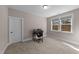 Bedroom with a window, neutral walls, carpet, and a small desk setup at 2609 Aster Ct, Apex, NC 27502