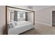 Bright bedroom featuring a canopy bed, neutral paint and a ceiling fan at 2609 Aster Ct, Apex, NC 27502