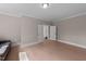 Spacious bonus room with neutral paint, hardwood floors, and plenty of natural light at 2609 Aster Ct, Apex, NC 27502