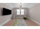 Bonus room with recessed lights, a chandelier, tv and a large window at 2609 Aster Ct, Apex, NC 27502