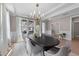 Elegant dining area with a large table, chandelier, and bright natural light from expansive windows at 2609 Aster Ct, Apex, NC 27502