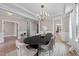 Stylish dining room with a tray ceiling, sophisticated chandelier, and neutral color palette at 2609 Aster Ct, Apex, NC 27502