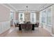 Bright dining room featuring a modern chandelier, large windows, and elegant decor at 2609 Aster Ct, Apex, NC 27502