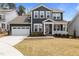 Charming two-story home features a covered front porch and a two-car garage at 2609 Aster Ct, Apex, NC 27502