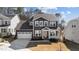 Beautiful two-story house with a well-manicured lawn, white trim, and two car garage at 2609 Aster Ct, Apex, NC 27502