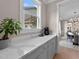 Bright kitchen area with views to the outdoors and including custom cabinetry and quartz countertops at 2609 Aster Ct, Apex, NC 27502