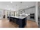 Spacious open-concept kitchen with a large island, pendant lighting, and access to the dining area and living room at 2609 Aster Ct, Apex, NC 27502