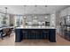 Gourmet kitchen featuring a large island with seating, pendant lighting, and modern appliances at 2609 Aster Ct, Apex, NC 27502