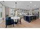 Modern kitchen with stainless steel appliances, custom cabinets, large island and views of the dining area and backyard at 2609 Aster Ct, Apex, NC 27502