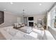 Bright living room with a fireplace, modern decor, and plenty of seating at 2609 Aster Ct, Apex, NC 27502