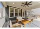 Comfortable screened-in porch with ceiling fan and cozy outdoor seating arrangement at 2609 Aster Ct, Apex, NC 27502