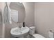 Cozy powder room featuring a pedestal sink, round mirror and white fixtures at 2609 Aster Ct, Apex, NC 27502
