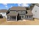 Back exterior view featuring a screened porch, patio, and spacious backyard at 2609 Aster Ct, Apex, NC 27502