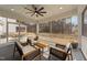 Screened porch with a ceiling fan and a seating area with 4 chairs around a wooden table at 2609 Aster Ct, Apex, NC 27502