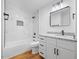 Stylish bathroom features marble tile shower and modern vanity with granite countertop at 2611 Atlantic St, Durham, NC 27707