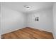 Cozy bedroom with hardwood floors, neutral walls, and a large window at 2611 Atlantic St, Durham, NC 27707