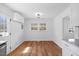 Dining area with hardwood floors and modern chandelier open to kitchen and backyard at 2611 Atlantic St, Durham, NC 27707