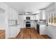Renovated kitchen boasts stainless steel appliances, granite countertops, and ample natural light at 2611 Atlantic St, Durham, NC 27707