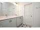 Bright bathroom featuring a double vanity, light gray cabinets, and decorative tile floors at 283 Beacon Dr, Pittsboro, NC 27312