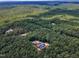 Expansive aerial view of a secluded property nestled among dense trees, highlighting the privacy and tranquility of the location at 295 Cedar Rock Trl, Fuquay Varina, NC 27526