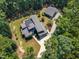 Stunning aerial view of a home with solar panels surrounded by lush greenery, showcasing its energy efficiency at 295 Cedar Rock Trl, Fuquay Varina, NC 27526