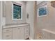 Bathroom with modern vanity, stone tiled walk-in shower and large window at 295 Cedar Rock Trl, Fuquay Varina, NC 27526