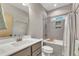 Bathroom featuring sleek vanity, gray backsplash, shower and tub combo at 295 Cedar Rock Trl, Fuquay Varina, NC 27526