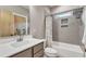 Modern bathroom with a gray tiled shower and tub combination and a floating vanity at 295 Cedar Rock Trl, Fuquay Varina, NC 27526