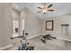 Upstairs bonus room featuring gym equipment, ceiling fan, and bright neutral colors at 295 Cedar Rock Trl, Fuquay Varina, NC 27526