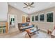 Upstairs bonus room featuring large windows, hardwood floors, and a ceiling fan at 295 Cedar Rock Trl, Fuquay Varina, NC 27526