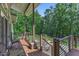 Inviting outdoor deck with wood flooring, contemporary railings, and cozy seating, perfect for relaxing and enjoying nature views at 295 Cedar Rock Trl, Fuquay Varina, NC 27526