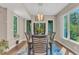 Elegant dining room with a wood table, modern lighting, and large windows overlooking the yard at 295 Cedar Rock Trl, Fuquay Varina, NC 27526