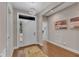 Bright and airy foyer with hardwood floors, contemporary lighting, and a welcoming entrance, creating a great first impression at 295 Cedar Rock Trl, Fuquay Varina, NC 27526