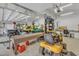 Open three-car garage with multiple vehicles and overhead lighting at 295 Cedar Rock Trl, Fuquay Varina, NC 27526