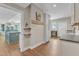 Hallway leading to kitchen with open concept and hardwood floors at 295 Cedar Rock Trl, Fuquay Varina, NC 27526