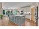 Modern kitchen with a large gray island, stainless steel appliances, and pendant lighting at 295 Cedar Rock Trl, Fuquay Varina, NC 27526