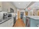 Well-equipped kitchen featuring stainless steel appliances, sleek cabinets, and an expansive marble island at 295 Cedar Rock Trl, Fuquay Varina, NC 27526