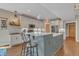 Stylish kitchen boasts a large island with marble counters, stainless appliances, and open layout at 295 Cedar Rock Trl, Fuquay Varina, NC 27526