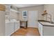 Laundry room featuring front loading washer and dryer, utility sink, and natural light at 295 Cedar Rock Trl, Fuquay Varina, NC 27526