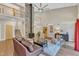 Light-filled living room boasts a stone fireplace, vaulted ceilings, a second floor balcony, and stylish decor at 295 Cedar Rock Trl, Fuquay Varina, NC 27526