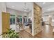 Bright living room with wood floors, stone accent wall, fireplace, and access to a private deck at 295 Cedar Rock Trl, Fuquay Varina, NC 27526