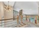Spacious loft with an eye-catching light fixture and a stone wall accent at 295 Cedar Rock Trl, Fuquay Varina, NC 27526